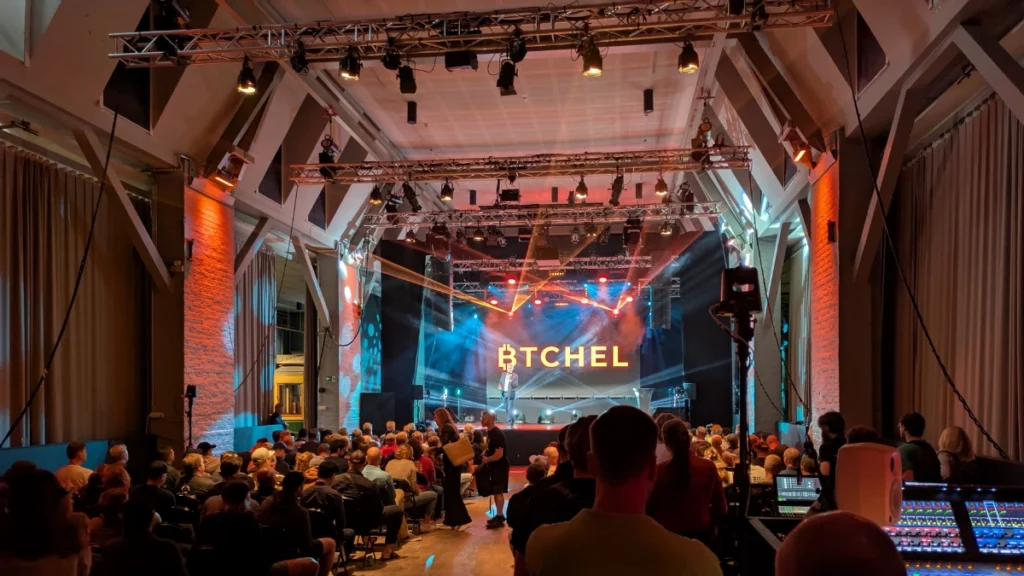 Main stage at BTCHEL 2025 in Helsinki, with a large audience attending a keynote on Bitcoin and self-custody.